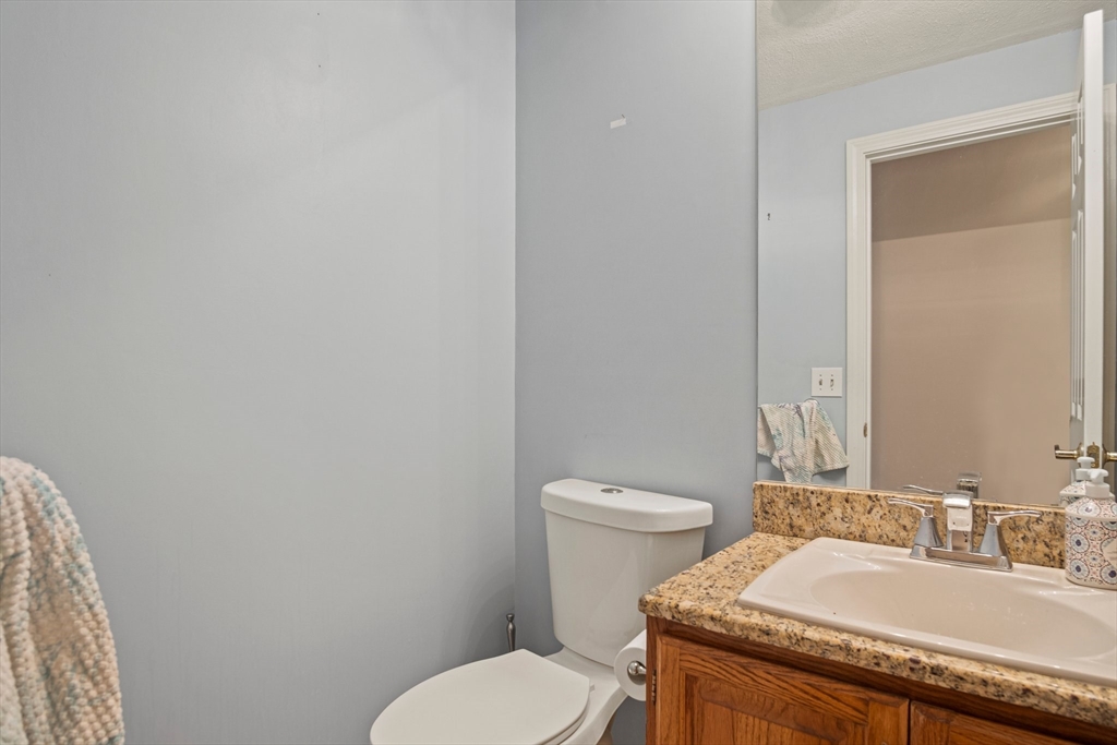 20 Casey Circle, Unit 20 Waltham, MA 02451 - Photo 12 of 38 a bathroom with a granite countertop toilet and a sink