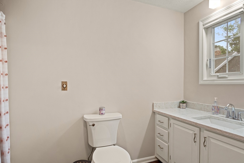 20 Casey Circle, Unit 20 Waltham, MA 02451 - Photo 18 of 38 a bathroom with a toilet sink vanity and mirror