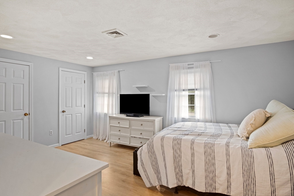 20 Casey Circle, Unit 20 Waltham, MA 02451 - Photo 20 of 38 a bedroom with a bed and a flat screen tv