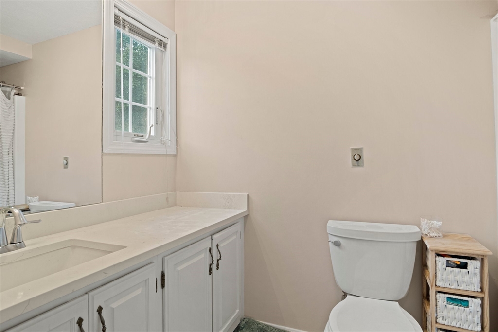 20 Casey Circle, Unit 20 Waltham, MA 02451 - Photo 22 of 38 a bathroom with a toilet sink and mirror