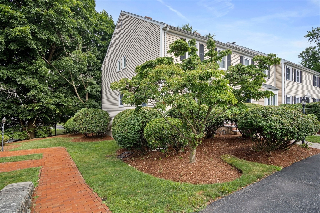 20 Casey Circle, Unit 20 Waltham, MA 02451 - Photo 31 of 38 a front view of a house with a yard and outdoor seating