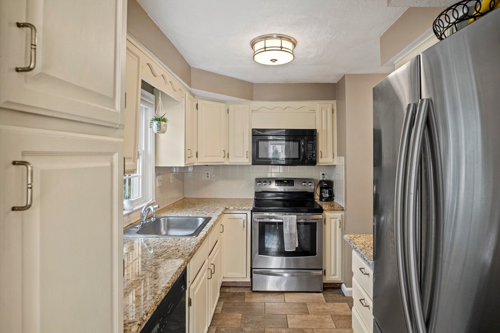 20 Casey Circle, Unit 20 Waltham, MA 02451 - Photo 6 of 38 a kitchen with stainless steel appliances granite countertop a refrigerator stove and sink