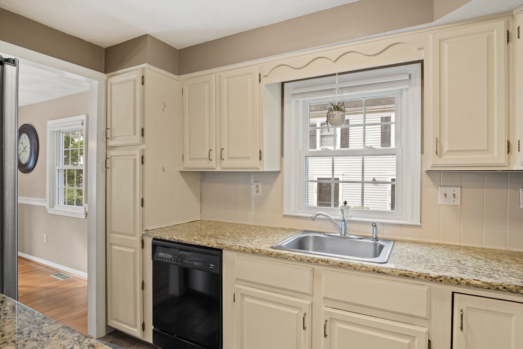 20 Casey Circle, Unit 20 Waltham, MA 02451 - Photo 7 of 38 a kitchen with granite countertop stainless steel appliances white cabinets and a sink