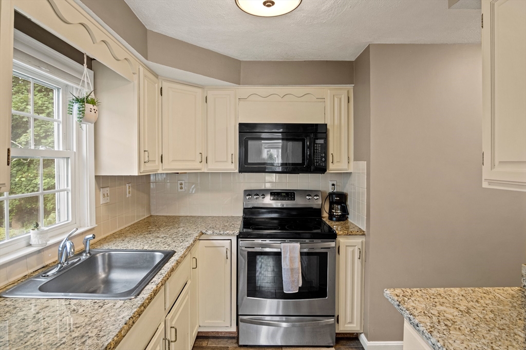 20 Casey Circle, Unit 20 Waltham, MA 02451 - Photo 8 of 38 a kitchen with granite countertop a sink and steel appliances