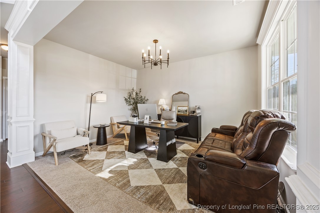 1709 Eagle Hill Road Fayetteville, NC 28312 - Photo 11 of 46 a living room with furniture a chandelier and a dining table