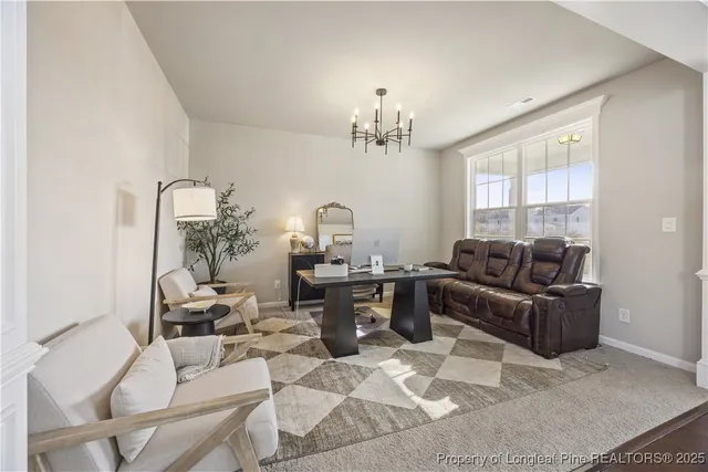 a living room with furniture and a chandelier