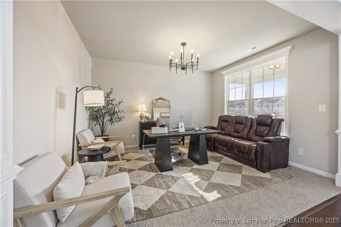 1709 Eagle Hill Road Fayetteville, NC 28312 - Photo 12 of 46 a living room with furniture and a chandelier