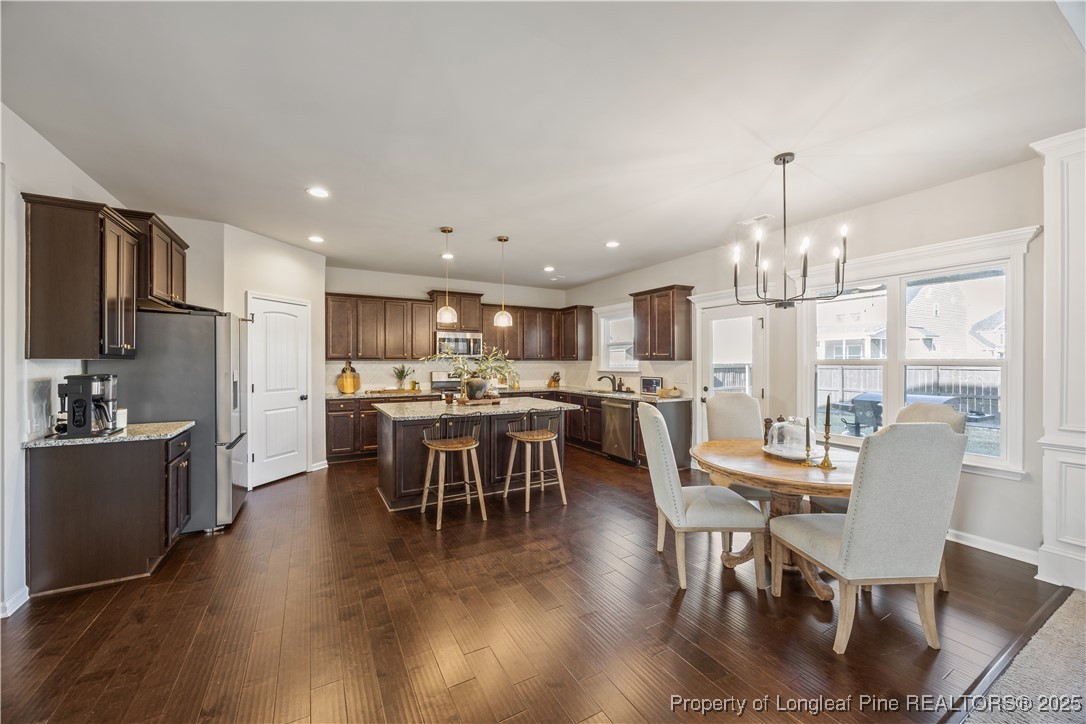 1709 Eagle Hill Road Fayetteville, NC 28312 - Photo 19 of 46 a view of a dining room with furniture a kitchen and chandelier