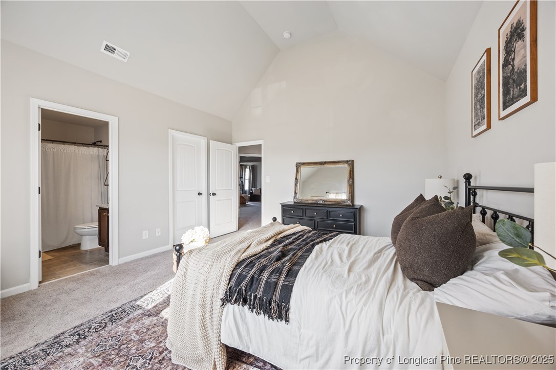 1709 Eagle Hill Road Fayetteville, NC 28312 - Photo 26 of 46 a bedroom with a bed and a mirror