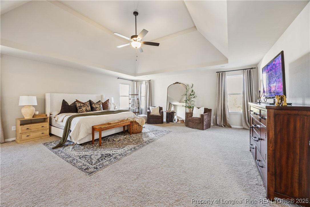1709 Eagle Hill Road Fayetteville, NC 28312 - Photo 29 of 46 a spacious bedroom with a bed a large mirror and furniture