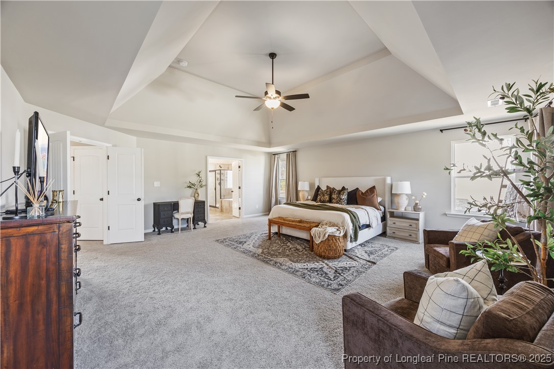 1709 Eagle Hill Road Fayetteville, NC 28312 - Photo 30 of 46 a bedroom with bed and a chandelier