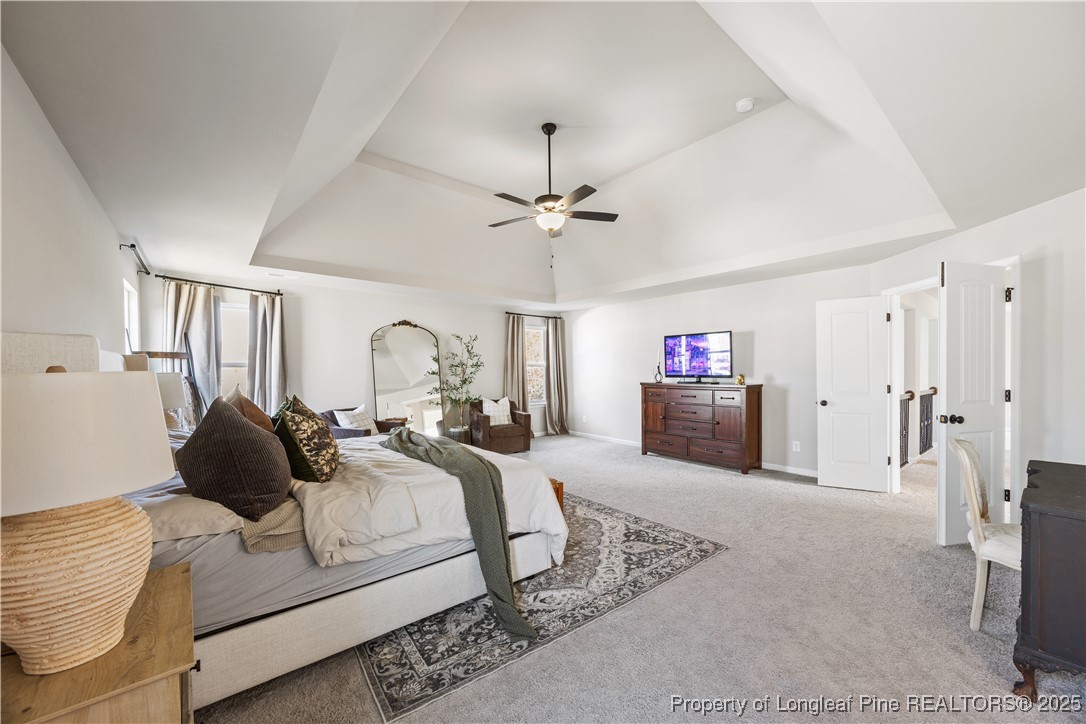 1709 Eagle Hill Road Fayetteville, NC 28312 - Photo 32 of 46 a spacious bedroom with a bed and a chandelier