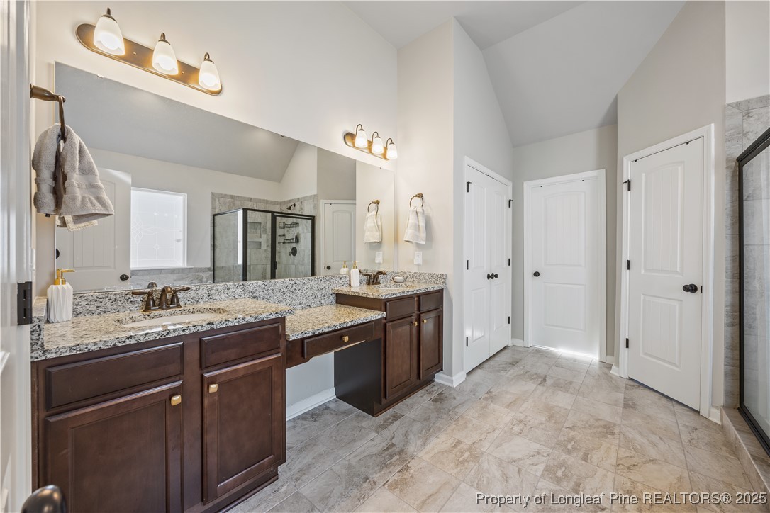 1709 Eagle Hill Road Fayetteville, NC 28312 - Photo 33 of 46 a spacious bathroom with a granite countertop sink a mirror and a