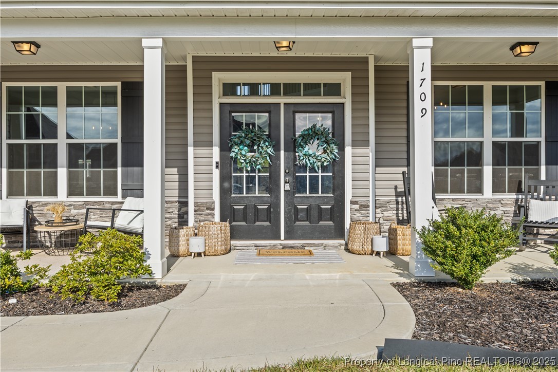 1709 Eagle Hill Road Fayetteville, NC 28312 - Photo 5 of 46 a front view of a house with a yard and potted plants