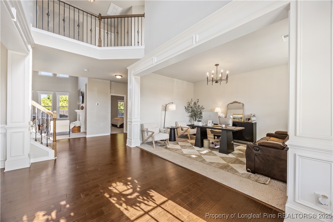 1709 Eagle Hill Road Fayetteville, NC 28312 - Photo 10 of 46 a living room with couches a dining table with wooden floor and dining table