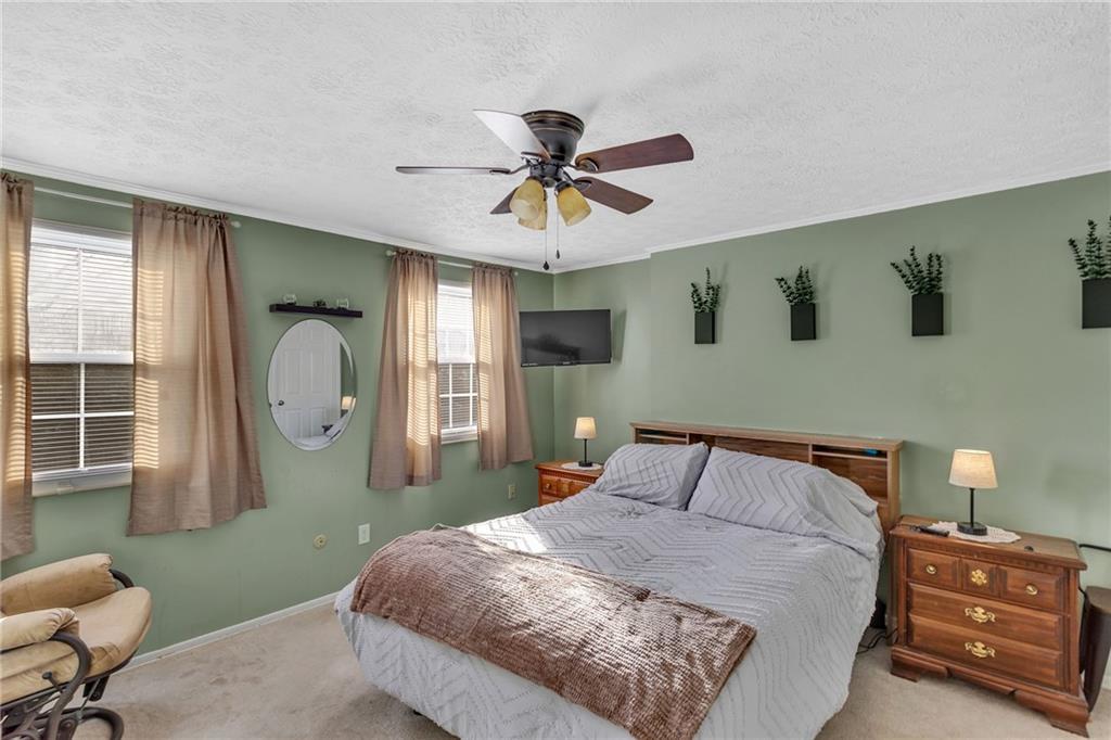 4 B Springwood Square Harwick, PA 15049 - Photo 19 of 32 a bedroom with a bed and a chandelier