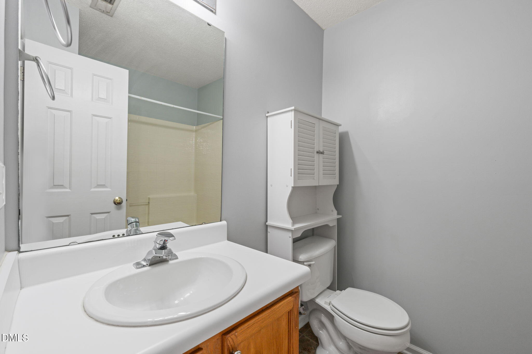 4701 Tommans Trail Raleigh, NC 27616 - Photo 10 of 36 a bathroom with a toilet a sink and mirror