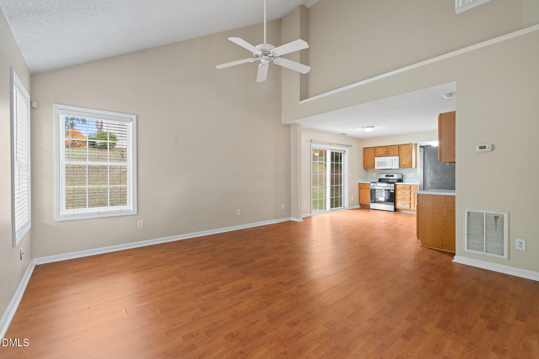 4701 Tommans Trail Raleigh, NC 27616 - Photo 30 of 36 an empty room with chandelier fan and windows