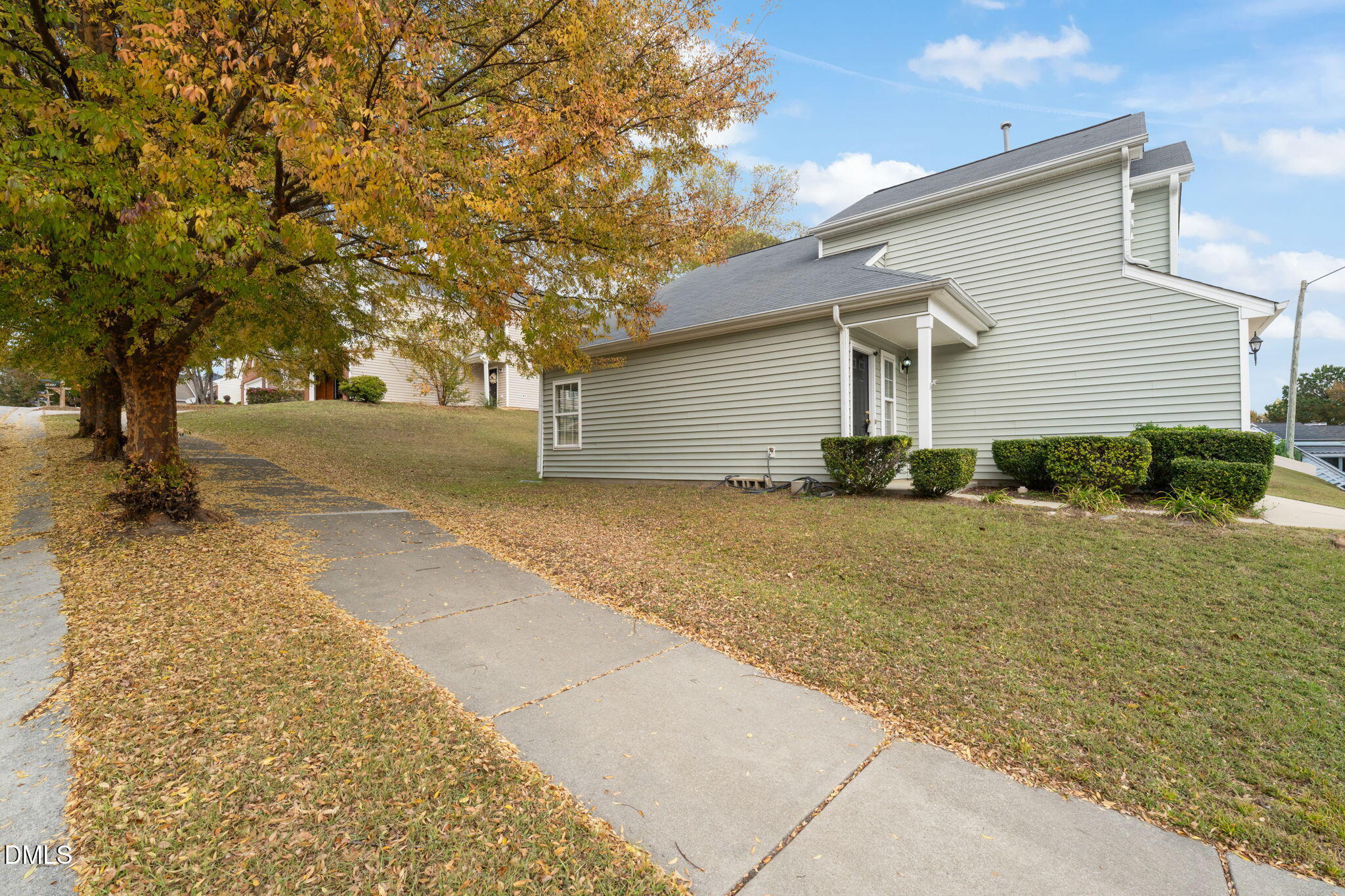 4701 Tommans Trail Raleigh, NC 27616 - Photo 4 of 36 a backyard of a house with large trees and outdoor seating