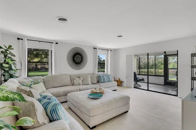 a living room with furniture and a floor to ceiling window
