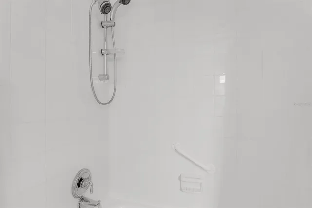 an aerial view of a city with lots of residential buildings ocean and mountain view in back