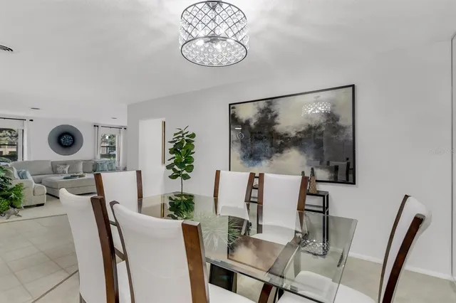 a living room with flat screen tv and floor to ceiling window