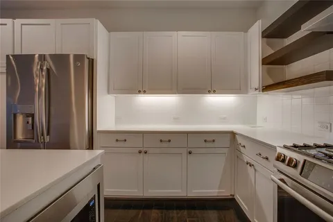 a kitchen with a sink cabinets and stainless steel appliances