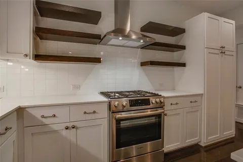 a stove top oven sitting inside of a kitchen