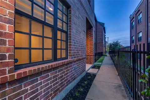a pathway of a house with a yard