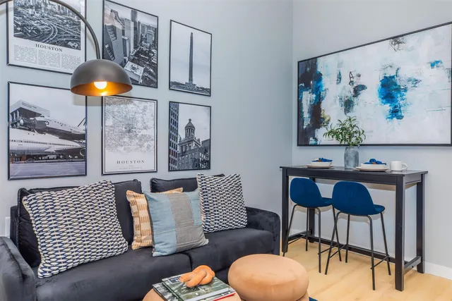 a living room with furniture and lamp