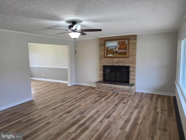 a kitchen with granite countertop a sink window and cabinets