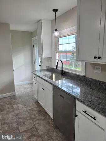 a kitchen with cabinets a refrigerator and a stove
