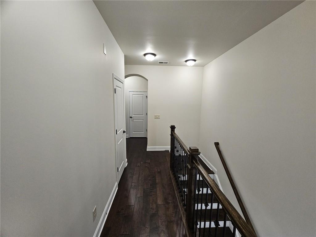 3920 Glenview Club Lane Duluth, GA 30097 - Photo 16 of 44 a view of a hallway with wooden floor and staircase