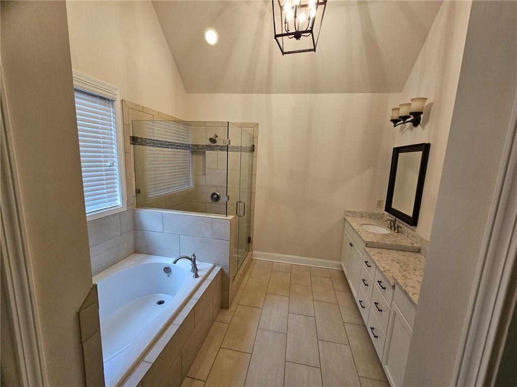 3920 Glenview Club Lane Duluth, GA 30097 - Photo 24 of 44 a bathroom with a tub a sink a mirror a shower and vanity