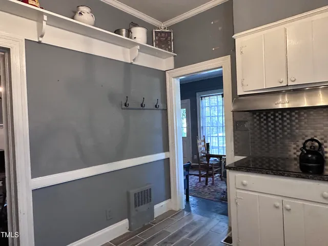 a kitchen with a refrigerator and a stove top oven