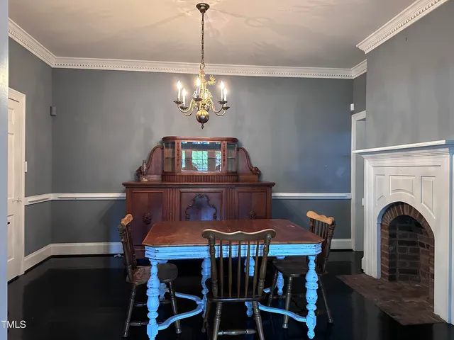 a view of a dining room with furniture and chandelier