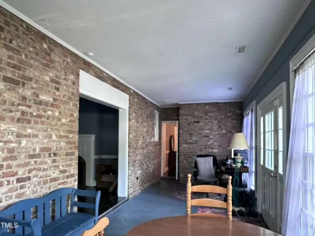 a living room with patio furniture and a fireplace