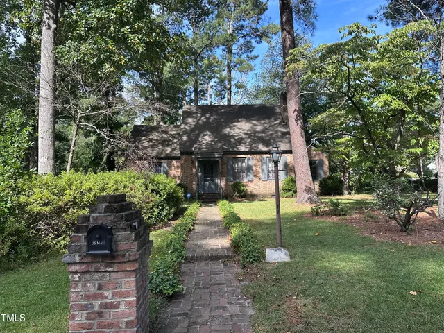 a view of a park with large trees