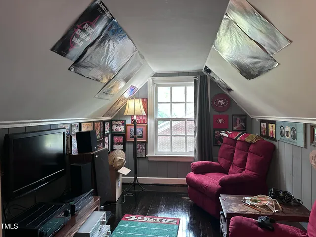 a living room with furniture a window and a flat screen tv
