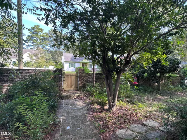 a front view of a house with lots of green space