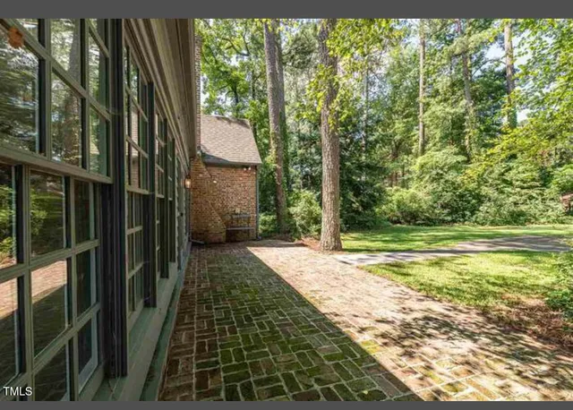 a view of a pathway of a house with a yard
