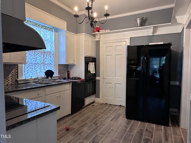 a kitchen with stainless steel appliances granite countertop a refrigerator and a stove