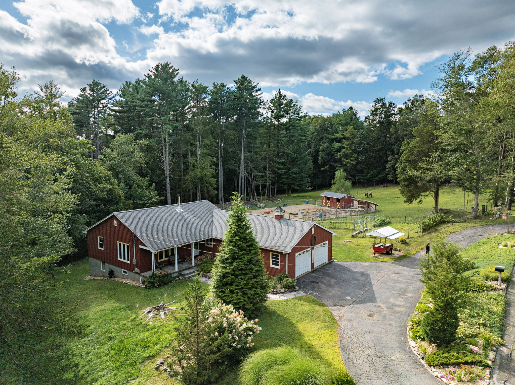 an aerial view of a house with backyard garden and outdoor seating