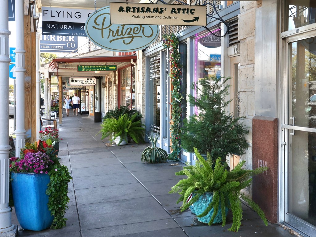 9361 Highway 290, Unit 118 Hye, TX 78635 - Photo 10 of 38 a front view of a building with potted plants