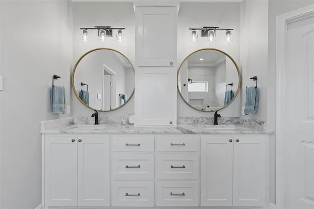 a bathroom with double sink and a mirror