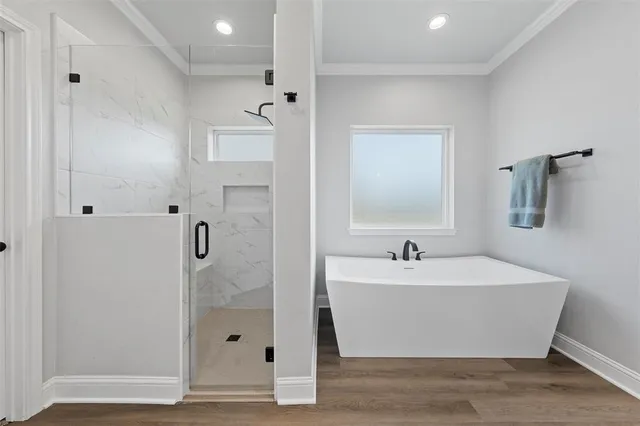 a bathroom with a bathtub and shower