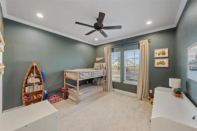 a bedroom with furniture and a ceiling fan
