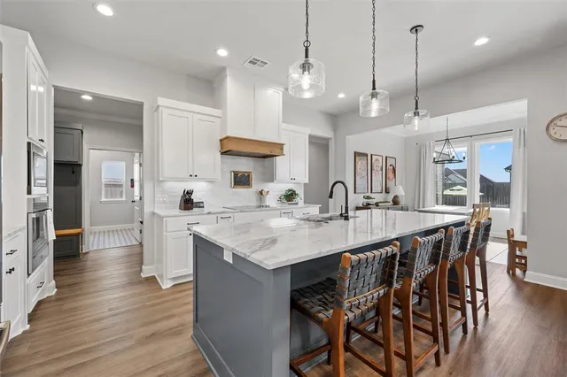 a large kitchen with a table and chairs