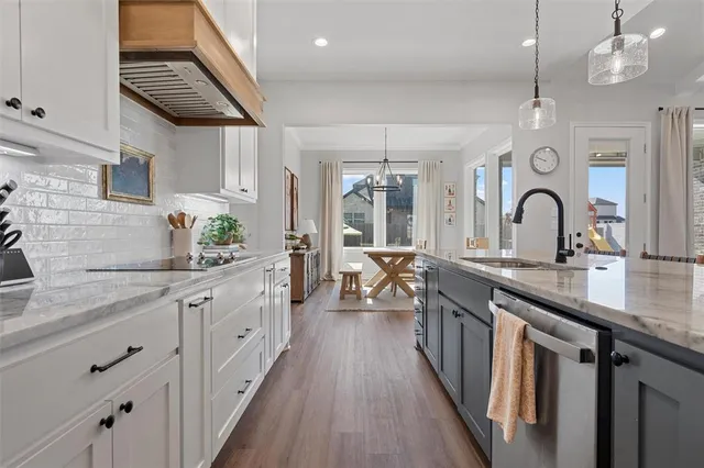 a kitchen with sink stove and cabinets