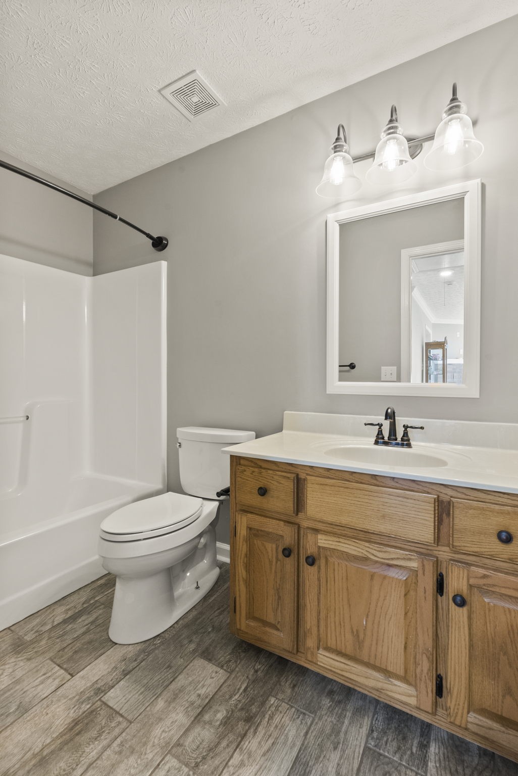574 S Road Cottontown, TN 37048 - Photo 22 of 35 a bathroom with a granite countertop toilet a sink and a mirror